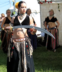 Troupe Leader Vikki Tests Her Sword for Sharpness